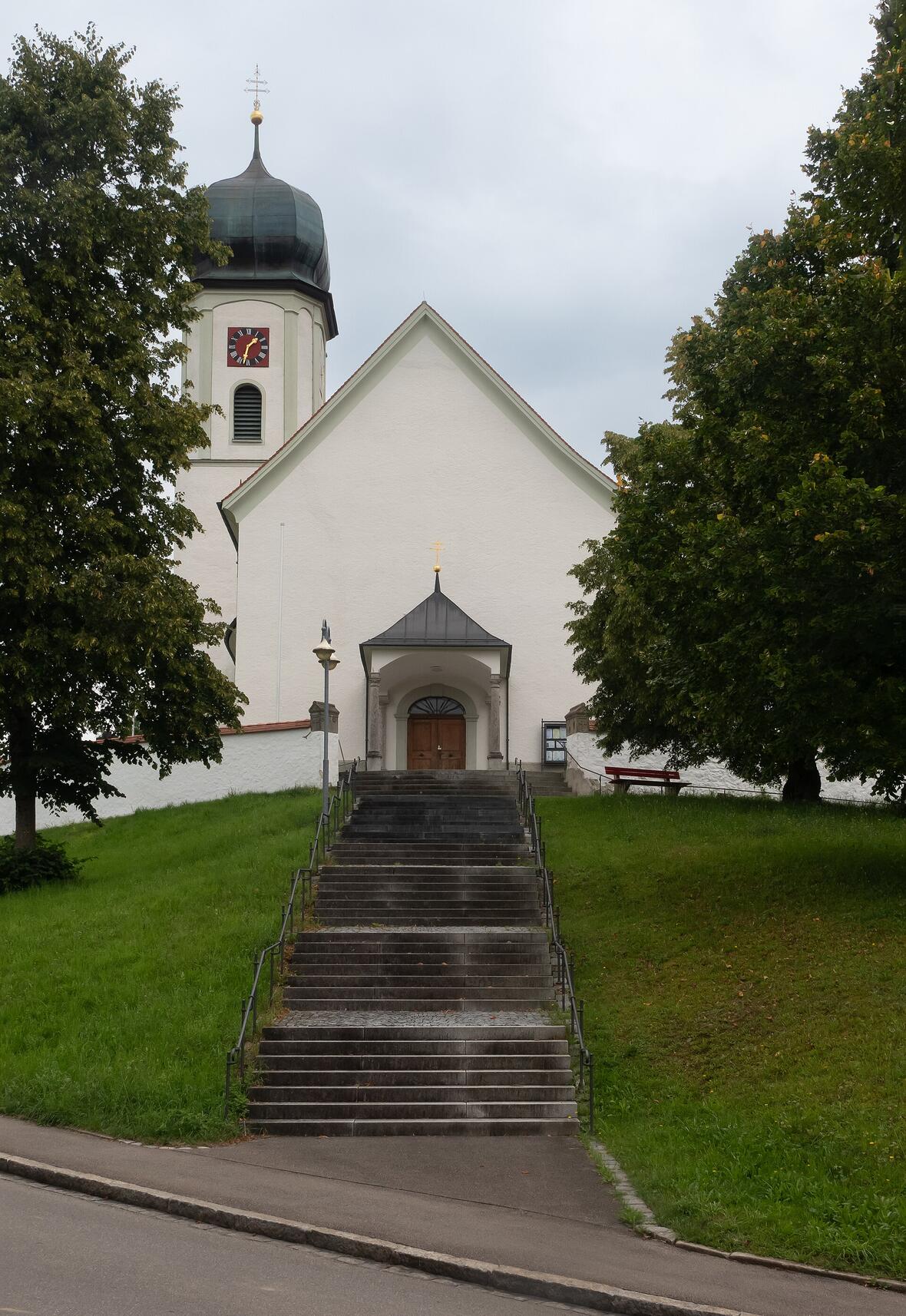 Wallfahrtskirche Mariä Himmelfahrt in Maria Thann mit Treppe und grüner Umgebung.